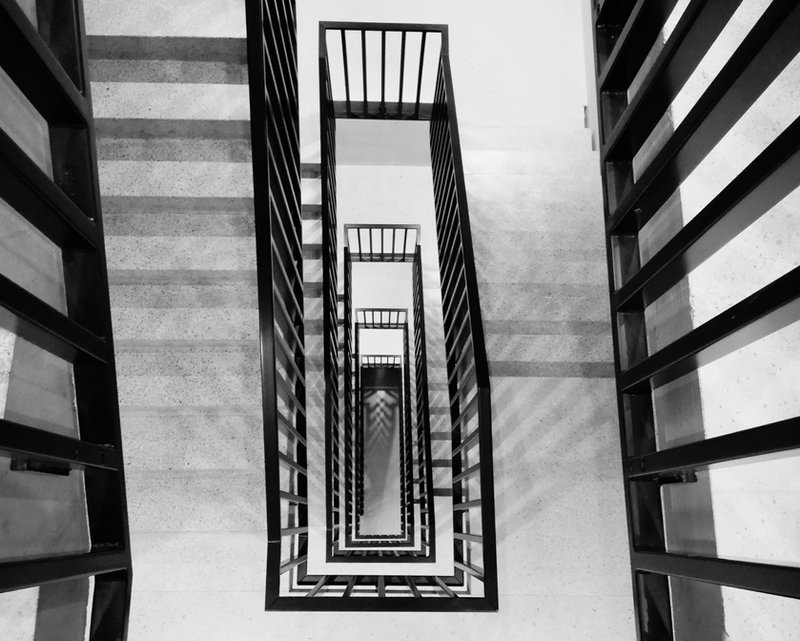 Person descending a staircase, illustrating safer downward vision with Morrow lenses